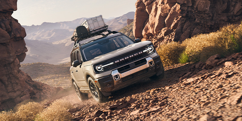 An all-new grey 2025 Ford Bronco Sport climbing up a loose rock desert mountain. - Franklin Ford Franklin, MA