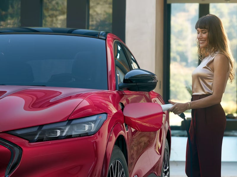 Woman putting the Mach-E to charge