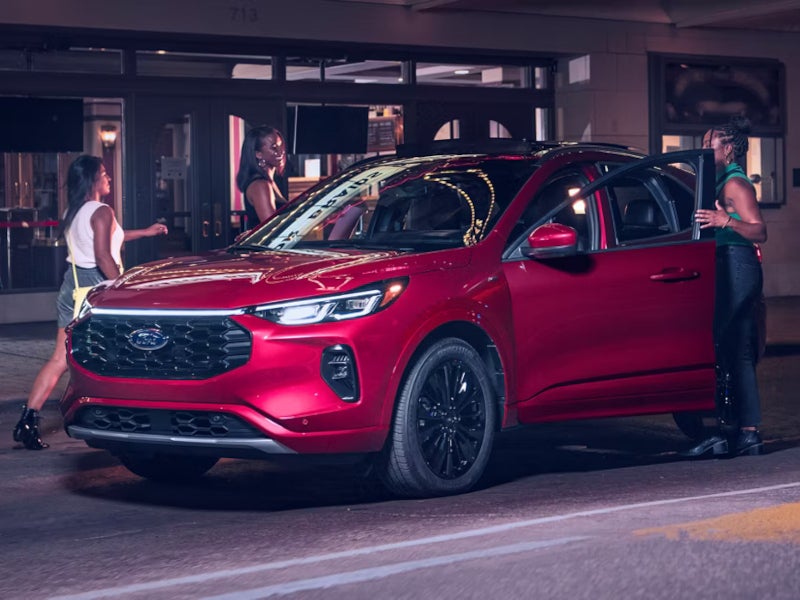 Friends getting into a Ford Escape Plug-in Hybrid