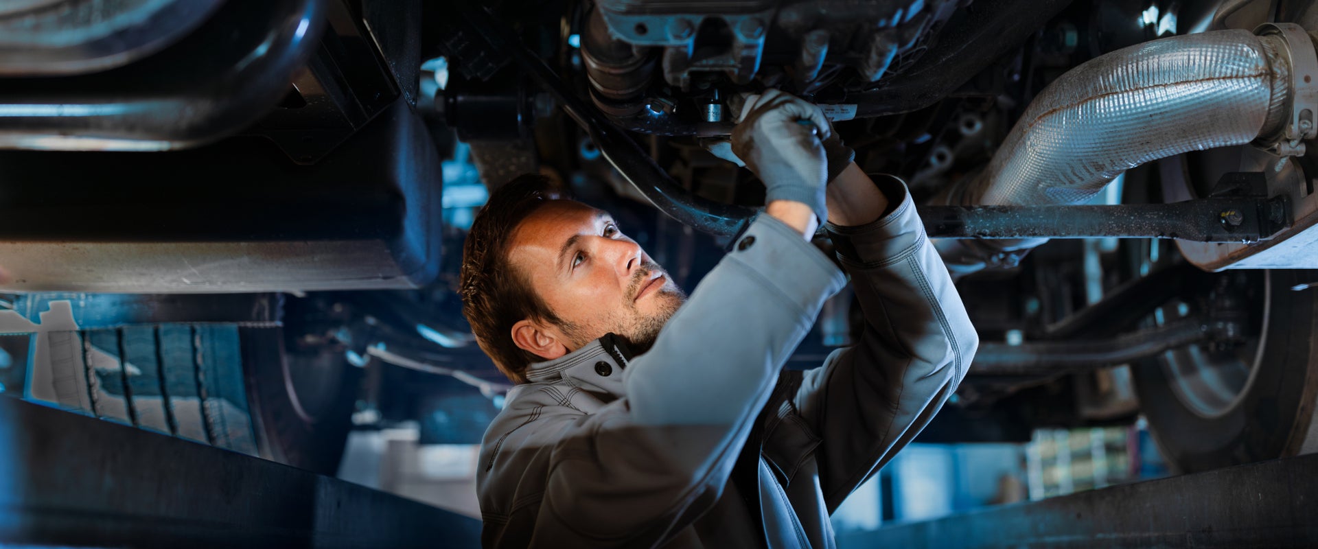 Franklin Ford Service Technician working underneath a vehicle