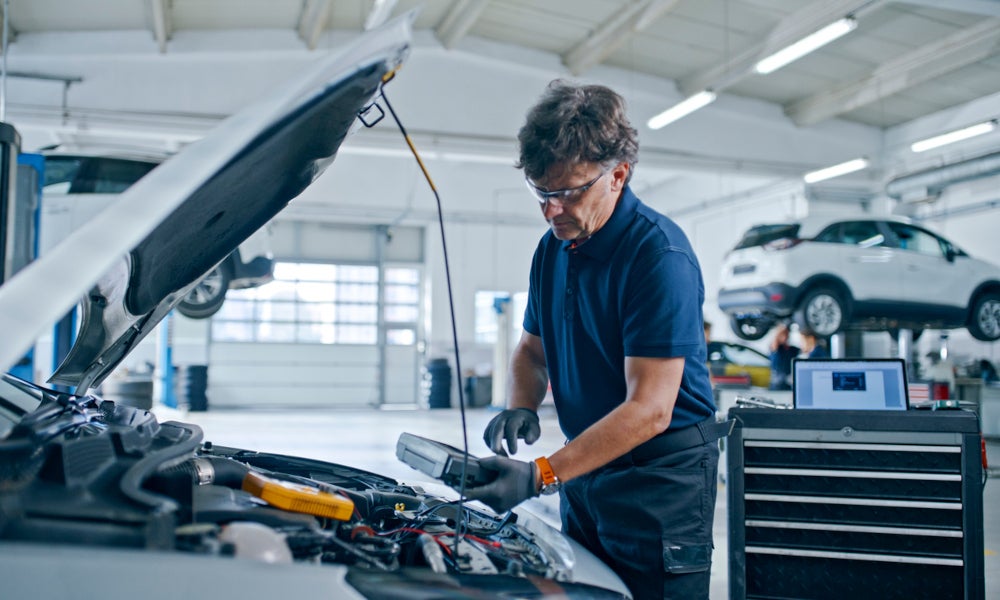 Frankin Ford Service Technician examining diagnosing vehicle